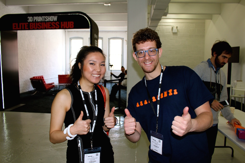 Aaron and Lily are all smiles in front of the 3D Printshow Elite Business Hub. 